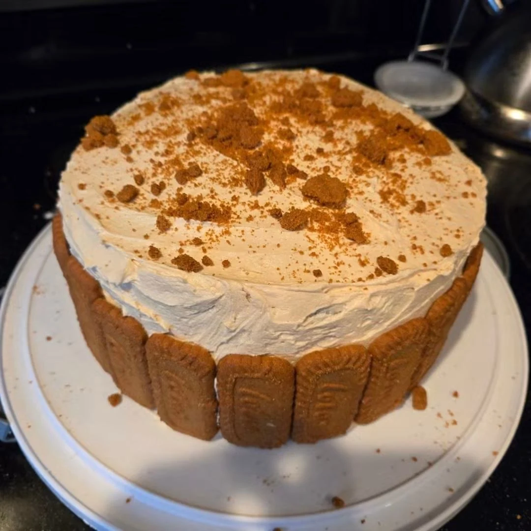 Tall cake with Lotus biscuits around the sides and crumbs on top